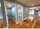 Hallway with hardwood floors leading to a modern bathroom with a tub and tiled shower at 356 Greenwood Nw Dr, Lilburn, GA 30047