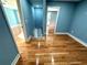 This hallway features hardwood floors and neutral paint. Stairs are pictured at 356 Greenwood Nw Dr, Lilburn, GA 30047