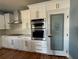 Kitchen with white cabinets, stainless steel appliances, a tile backsplash, and a pantry with decorative glass at 356 Greenwood Nw Dr, Lilburn, GA 30047