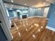 This living room features hardwood floors, neutral paint, recessed lighting, and access to the kitchen at 356 Greenwood Nw Dr, Lilburn, GA 30047