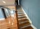 Stairs feature hardwood steps, neutral paint, and hardwood floors on the lower level at 356 Greenwood Nw Dr, Lilburn, GA 30047