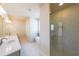 Bathroom featuring double sinks, soaker tub, glass shower, and modern fixtures at 5410 Crow Dr, Cumming, GA 30041