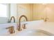 Close-up of bathroom with a marble countertop, modern fixtures, and a vanity mirror at 5410 Crow Dr, Cumming, GA 30041