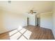 Bright bedroom with hardwood floors, neutral walls, white trim, and a ceiling fan at 5410 Crow Dr, Cumming, GA 30041
