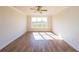 Bedroom with hardwood floors, neutral walls, and a large window letting in plenty of natural light at 5410 Crow Dr, Cumming, GA 30041