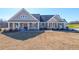 Charming single-story home featuring a covered front porch, stone accents, and manicured lawn at 5410 Crow Dr, Cumming, GA 30041