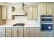 Modern kitchen featuring custom cabinets, herringbone backsplash, and stainless steel appliances at 5410 Crow Dr, Cumming, GA 30041