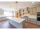 Gourmet kitchen with a large island, stainless steel appliances, and custom cabinetry at 5410 Crow Dr, Cumming, GA 30041