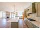 Open kitchen with a center island, stainless steel appliances, and stylish pendant lighting at 5410 Crow Dr, Cumming, GA 30041