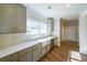 Modern kitchen featuring sleek cabinets, quartz countertops, herringbone backsplash, and stainless steel appliances at 5410 Crow Dr, Cumming, GA 30041