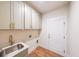 Well-organized laundry room featuring cabinets, modern sink, and plenty of storage space at 5410 Crow Dr, Cumming, GA 30041