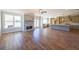 Open-concept living room featuring a stone fireplace, hardwood floors, and access to the kitchen at 5410 Crow Dr, Cumming, GA 30041