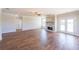 Bright living room features a stone fireplace, hardwood floors, and natural light from the french doors at 5410 Crow Dr, Cumming, GA 30041