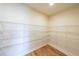 Walk-in pantry with wooden flooring and ample wire shelving for organized storage at 5410 Crow Dr, Cumming, GA 30041