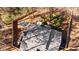 Aerial view of the home featuring a backyard with firepit and partially wooded lot at 181 Arrowood Ln, Alpharetta, GA 30009