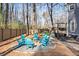 Cozy backyard firepit area with Adirondack chairs surrounded by a wooded fence at 181 Arrowood Ln, Alpharetta, GA 30009