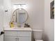 Bright bathroom with a white vanity, modern lighting, and a round mirror at 181 Arrowood Ln, Alpharetta, GA 30009