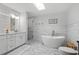 Elegant bathroom with a soaking tub, modern vanity, and stylish tile work at 181 Arrowood Ln, Alpharetta, GA 30009