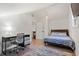 A well-lit bedroom with a bed, desk, and hardwood floors, ideal for a restful retreat at 181 Arrowood Ln, Alpharetta, GA 30009