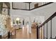 Bright foyer featuring hardwood floors, staircase, dining area and a glimpse of the living room at 181 Arrowood Ln, Alpharetta, GA 30009