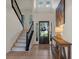 Bright foyer with hardwood floors, a staircase, and a glimpse of the outdoor scenery through the front door at 181 Arrowood Ln, Alpharetta, GA 30009