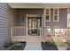 Inviting front porch with decorative railings, house number, and a glimpse of the charming exterior at 181 Arrowood Ln, Alpharetta, GA 30009