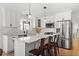 Bright kitchen features white cabinets, stainless steel appliances, a marble counter top, and stylish pendant lighting at 181 Arrowood Ln, Alpharetta, GA 30009