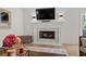 Living room with white fireplace, hardwood flooring, and stylish accents at 181 Arrowood Ln, Alpharetta, GA 30009