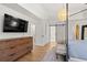Charming main bedroom with a bed, dresser, and sliding door to a bathroom at 181 Arrowood Ln, Alpharetta, GA 30009