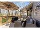 Relaxing outdoor deck with a dining table, umbrella and a treed backyard view at 181 Arrowood Ln, Alpharetta, GA 30009