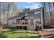 Stylish home with a deck, a well-maintained lawn, and mature trees in a private backyard at 181 Arrowood Ln, Alpharetta, GA 30009
