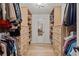 Spacious walk-in closet with custom built-in shelves and drawers for organized storage at 181 Arrowood Ln, Alpharetta, GA 30009