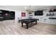 Basement game room with a pool table, brick accent wall, and a wet bar in the background at 438 Southland Cir, Canton, GA 30115