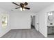 Bright bedroom with a ceiling fan, plush carpet, and an ensuite bathroom at 6042 Creekford Dr, Lithonia, GA 30058