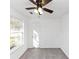 Bright bedroom with a ceiling fan, neutral carpeting, and a window for natural light at 6042 Creekford Dr, Lithonia, GA 30058