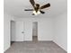 Cozy bedroom featuring a ceiling fan, carpet flooring, and freshly painted white walls at 6042 Creekford Dr, Lithonia, GA 30058