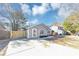 Charming one-story home featuring gray siding, a well-manicured yard, and a concrete driveway at 6042 Creekford Dr, Lithonia, GA 30058