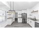 Bright kitchen with stainless steel appliances, white cabinetry, and modern countertops at 6042 Creekford Dr, Lithonia, GA 30058