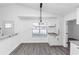 Bright eat-in kitchen featuring granite countertops, white cabinets, and sleek gray flooring at 6042 Creekford Dr, Lithonia, GA 30058