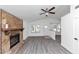 Inviting living room showcasing a stone fireplace, vaulted ceilings, and modern gray flooring at 6042 Creekford Dr, Lithonia, GA 30058