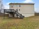 Backyard showcasing a wooden deck with stairs leading to the yard at 641 Morningside Dr, Stockbridge, GA 30281