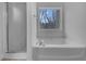 Bathroom showcasing a soaking tub with window and a stand-up shower at 641 Morningside Dr, Stockbridge, GA 30281