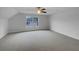 An empty bedroom featuring soft carpet and a large window at 641 Morningside Dr, Stockbridge, GA 30281