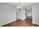 Dining room area showcasing hardwood floors, decorative molding, and a charming chandelier at 641 Morningside Dr, Stockbridge, GA 30281