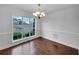 Dining room area showcasing hardwood floors, decorative molding, and a charming chandelier at 641 Morningside Dr, Stockbridge, GA 30281