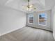 Spacious main bedroom features a ceiling fan, two windows and neutral-colored walls and carpet at 641 Morningside Dr, Stockbridge, GA 30281