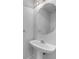 Cozy powder room with a modern pedestal sink and a decorative mirror at 641 Morningside Dr, Stockbridge, GA 30281