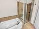 Bathroom featuring tiled shower and tub combo with glass doors and bronze fixtures at 789 Liberty Commons Nw Dr, Atlanta, GA 30314