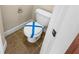 Small bathroom includes tile floors, a toilet with blue tape, and a light beige wall at 789 Liberty Commons Nw Dr, Atlanta, GA 30314