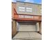 Townhouse back with a garage, wood siding, and a red wood deck at 789 Liberty Commons Nw Dr, Atlanta, GA 30314